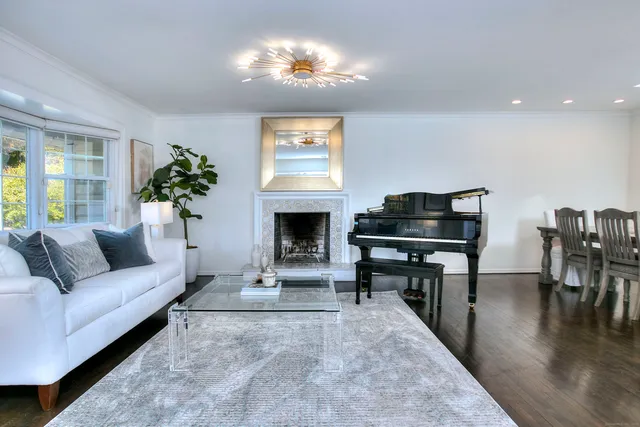 a living room with furniture a fireplace and a flat screen tv