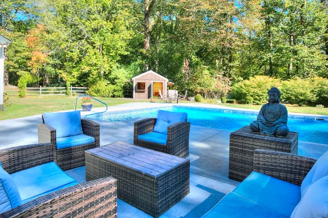 a view of a house with backyard and sitting area