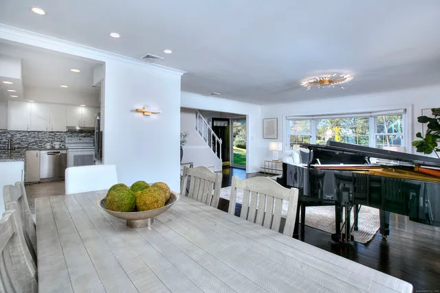 a living room with furniture and kitchen view