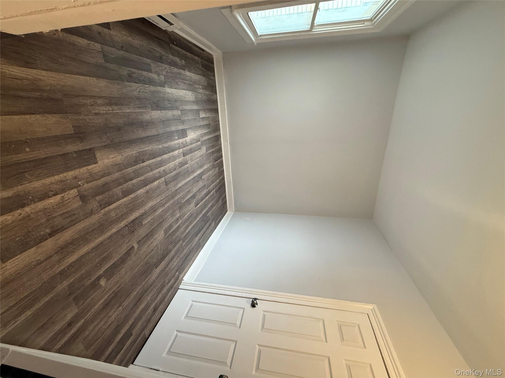 17 Conklin Street, Unit 1 Poughkeepsie, NY 12601 - Photo 12 of 17 Spare room featuring dark wood finished floors and a baseboard radiator