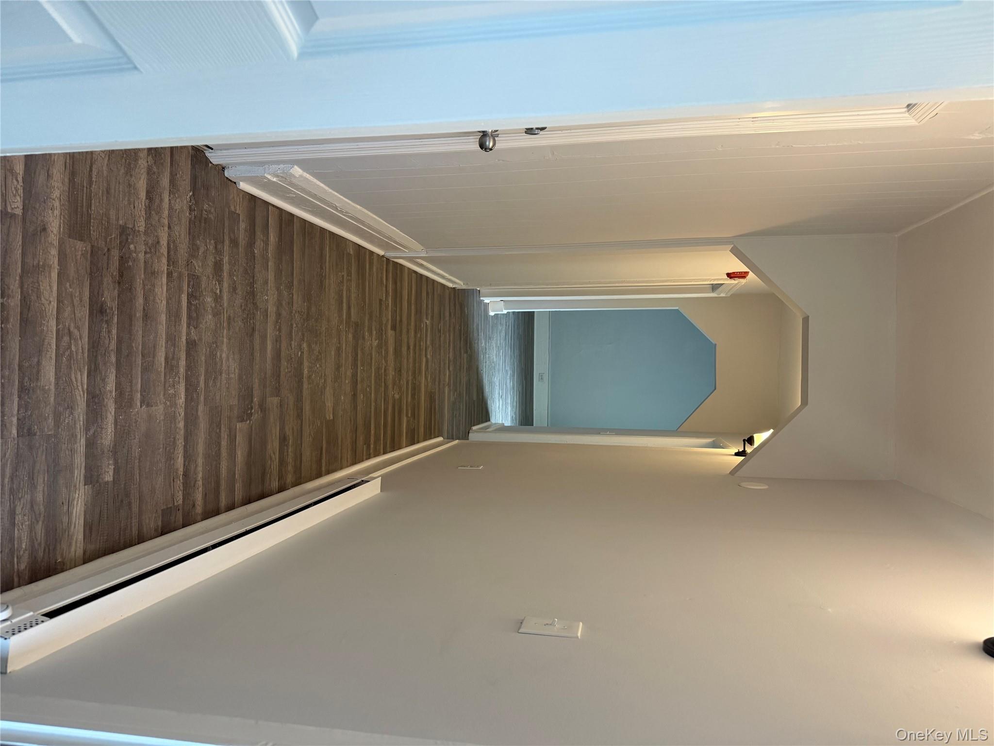 17 Conklin Street, Unit 1 Poughkeepsie, NY 12601 - Photo 2 of 17 Hallway with a baseboard heating unit, dark wood-type flooring, and arched walkways