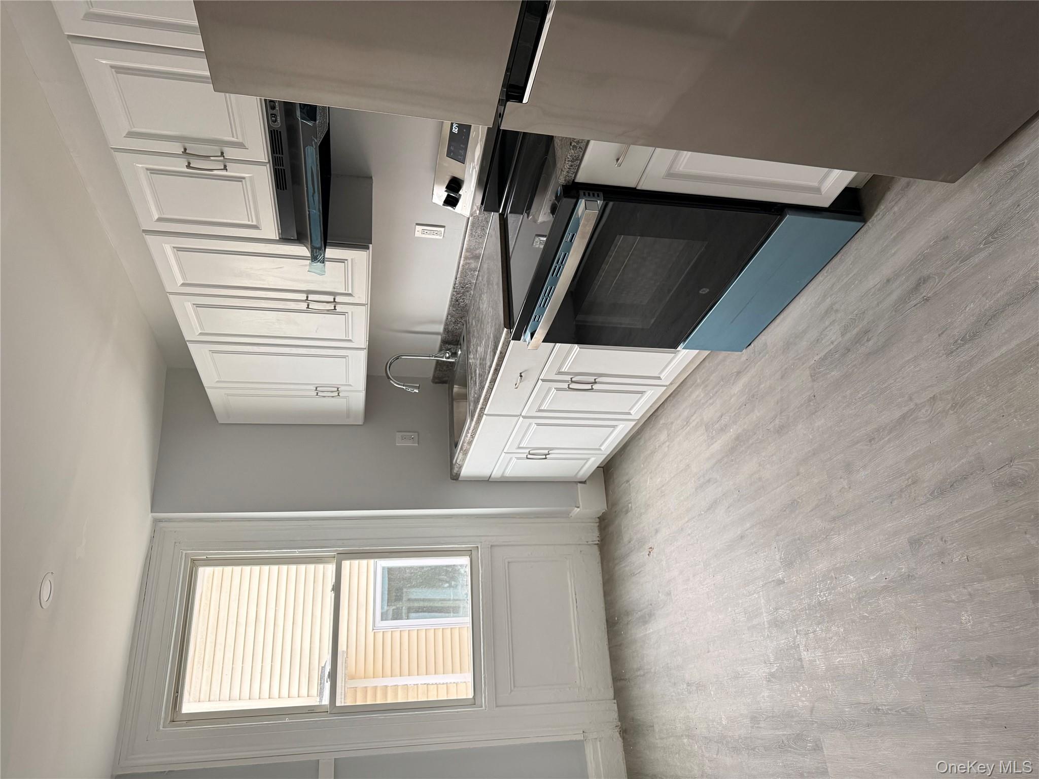 17 Conklin Street, Unit 1 Poughkeepsie, NY 12601 - Photo 7 of 17 Kitchen featuring stove, refrigerator, white cabinets, light wood-style floors, and ventilation hood