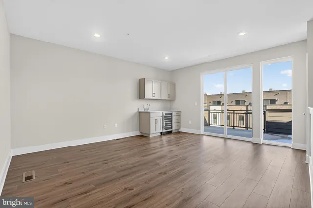 a view of kitchen with stainless steel appliances refrigerator and cabinets