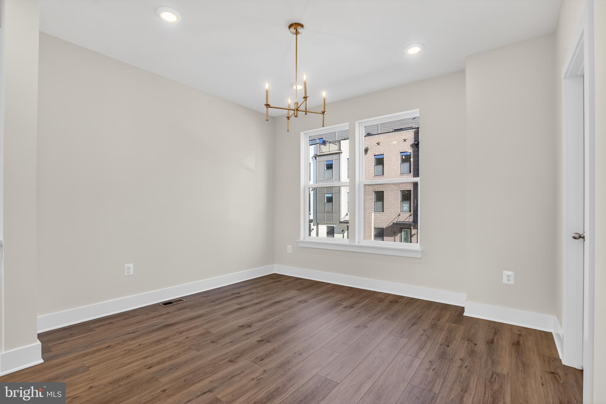2716 Light Street Baltimore, MD 21230 - Photo 6 of 20 an empty room with wooden floor chandelier and windows