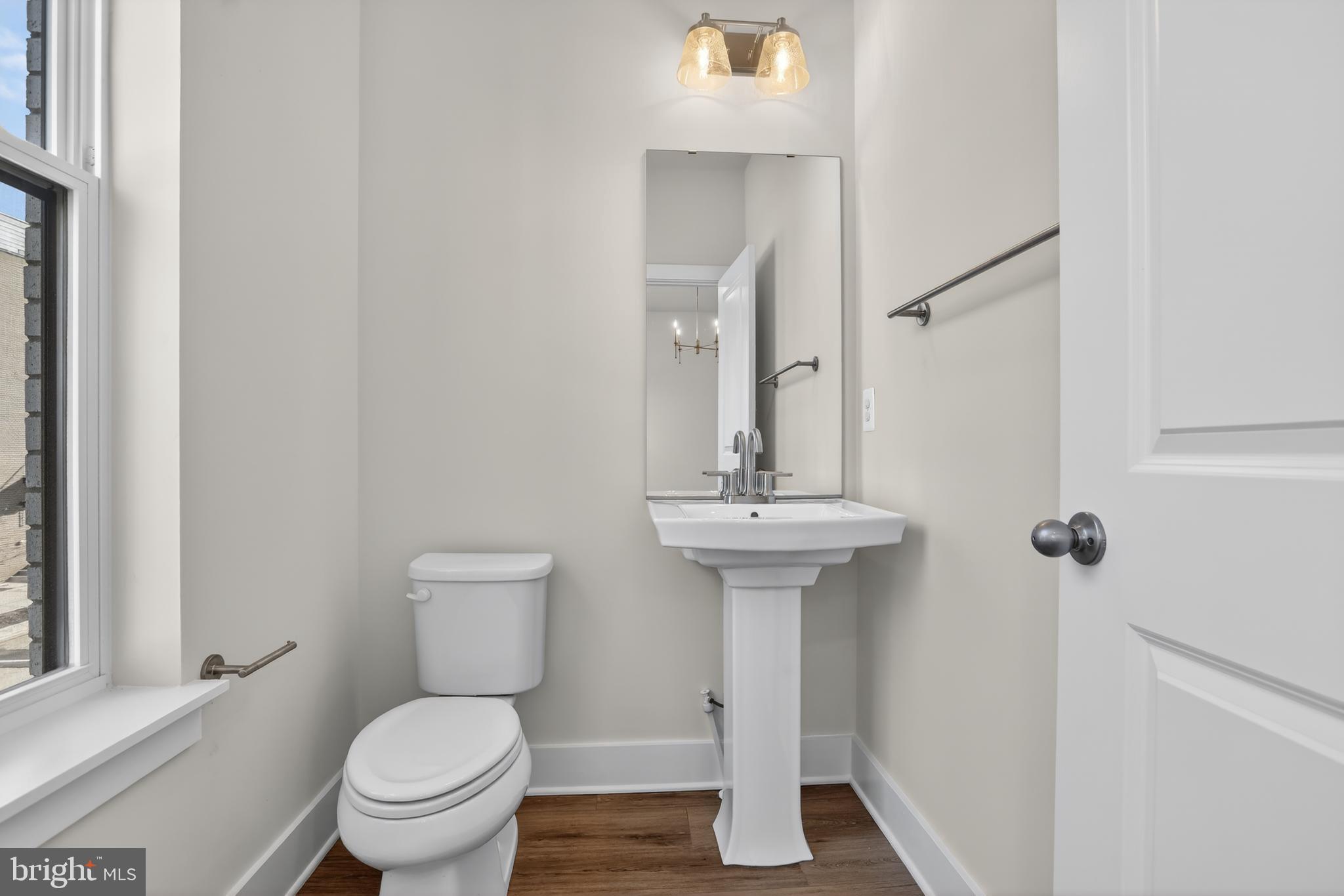 2716 Light Street Baltimore, MD 21230 - Photo 7 of 20 a bathroom with a sink toilet and a mirror
