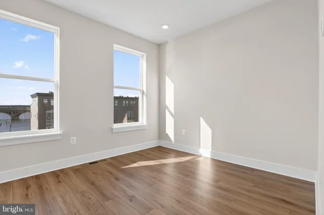 wooden floor in an empty room with a window