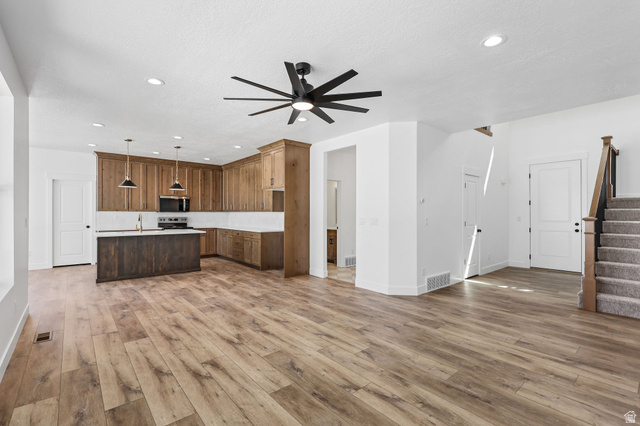 1144 South 4475 West West Point, UT 84015 - Photo 5 of 30 Open-concept living space with wood-finish flooring, a contemporary ceiling fan, and recessed lighting