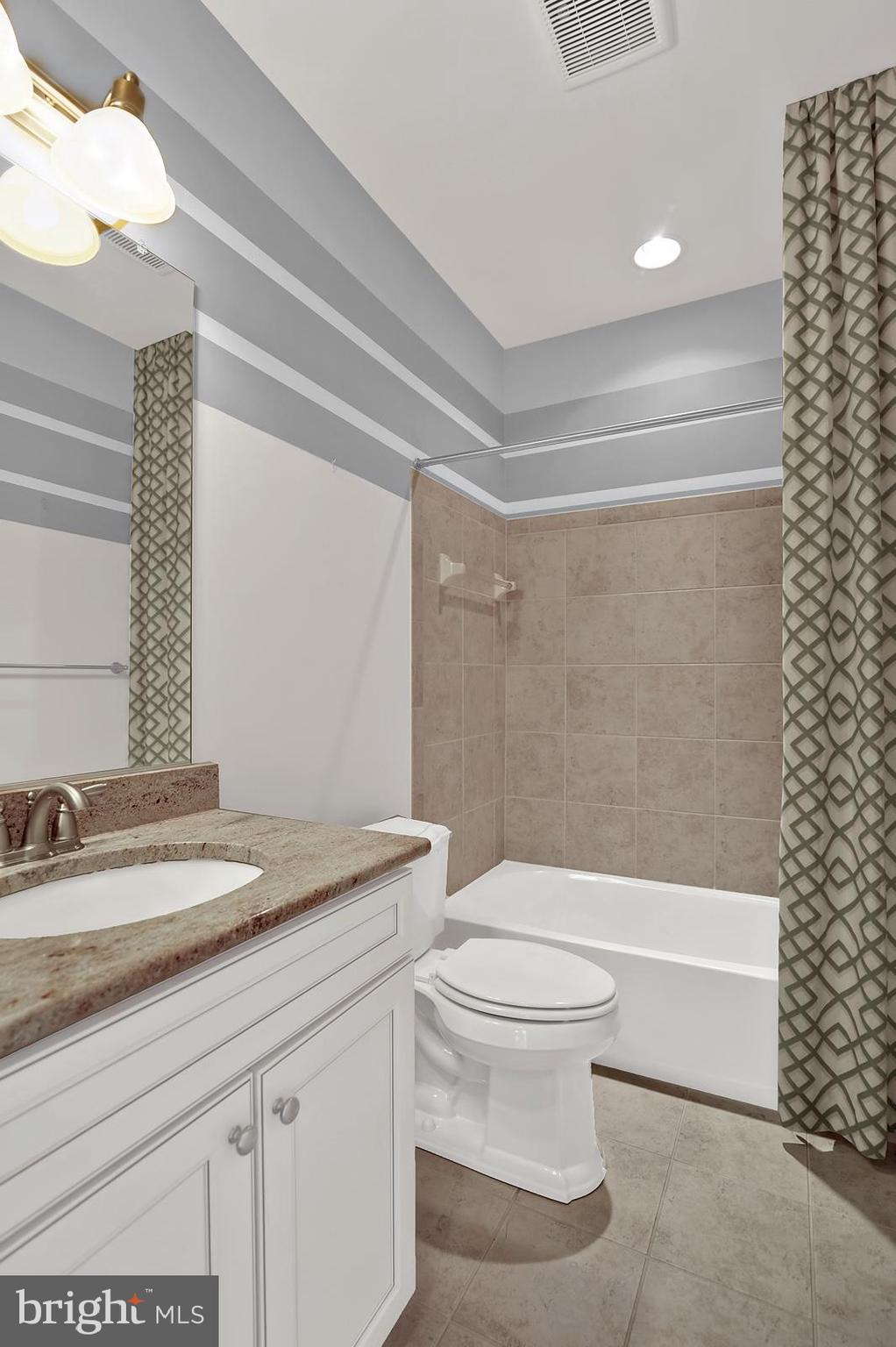 16 Fuji Court Dover, DE 19901 - Photo 6 of 13 a bathroom with a granite countertop sink a toilet a mirror and bathtub