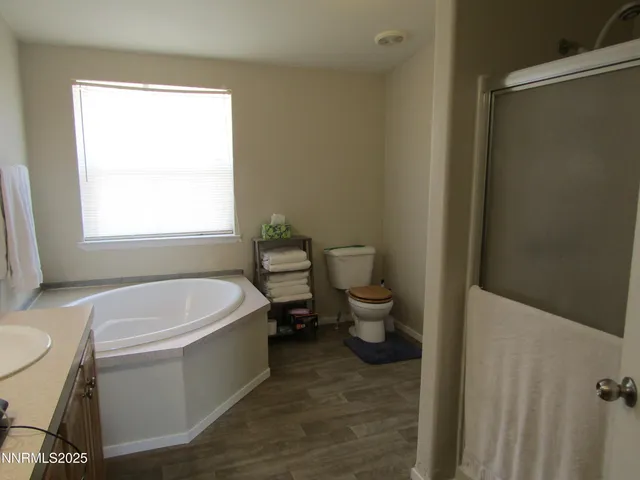 a bathroom with a sink toilet and window