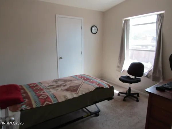 a bedroom with a workspace