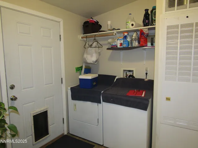 a view of a storage and utility room with washer and dryer