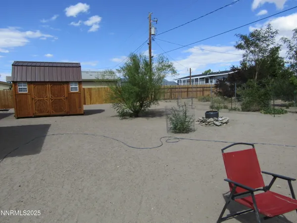 a backyard of a house with table and chairs