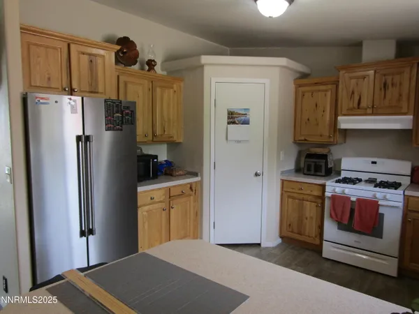 a kitchen with stainless steel appliances granite countertop a refrigerator stove and sink