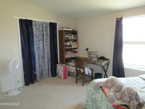 a bedroom with bed and a window