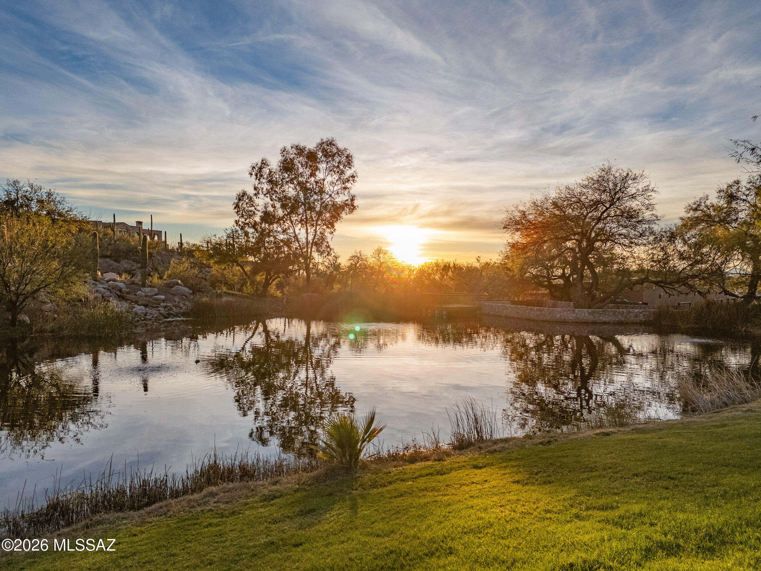 13630 East Sahuaro Sunset Road Tucson, AZ 85749 - Photo 45 of 47 a view of a lake with a mountain in the background