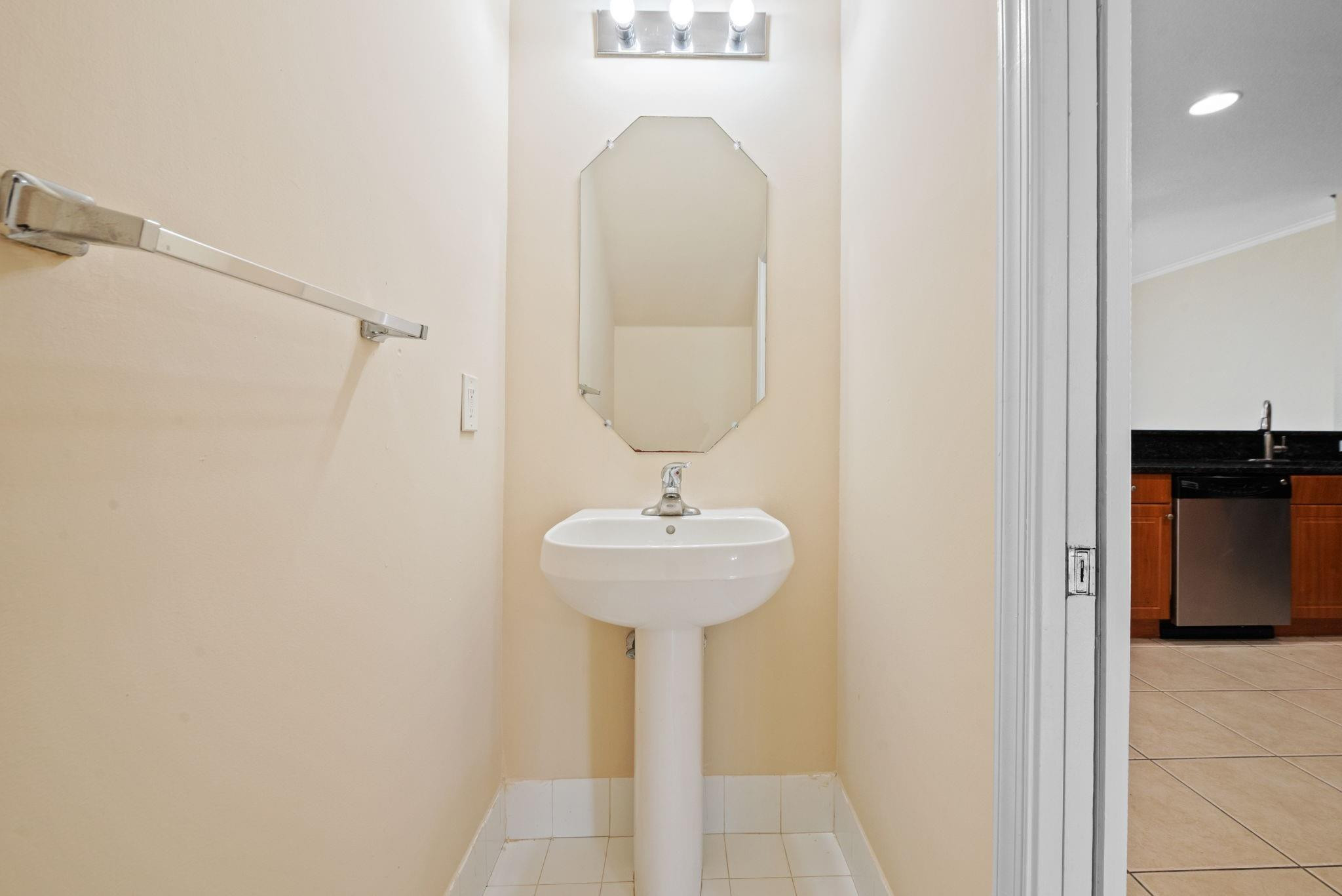 8299 Southwest 27th Street, Unit 101 Miramar, FL 33025 - Photo 11 of 30 a bathroom with a sink a mirror and a shower