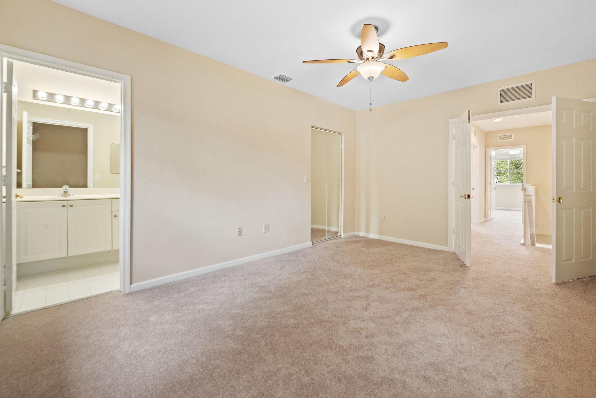 8299 Southwest 27th Street, Unit 101 Miramar, FL 33025 - Photo 13 of 30 an empty room with closet and a chandelier fan