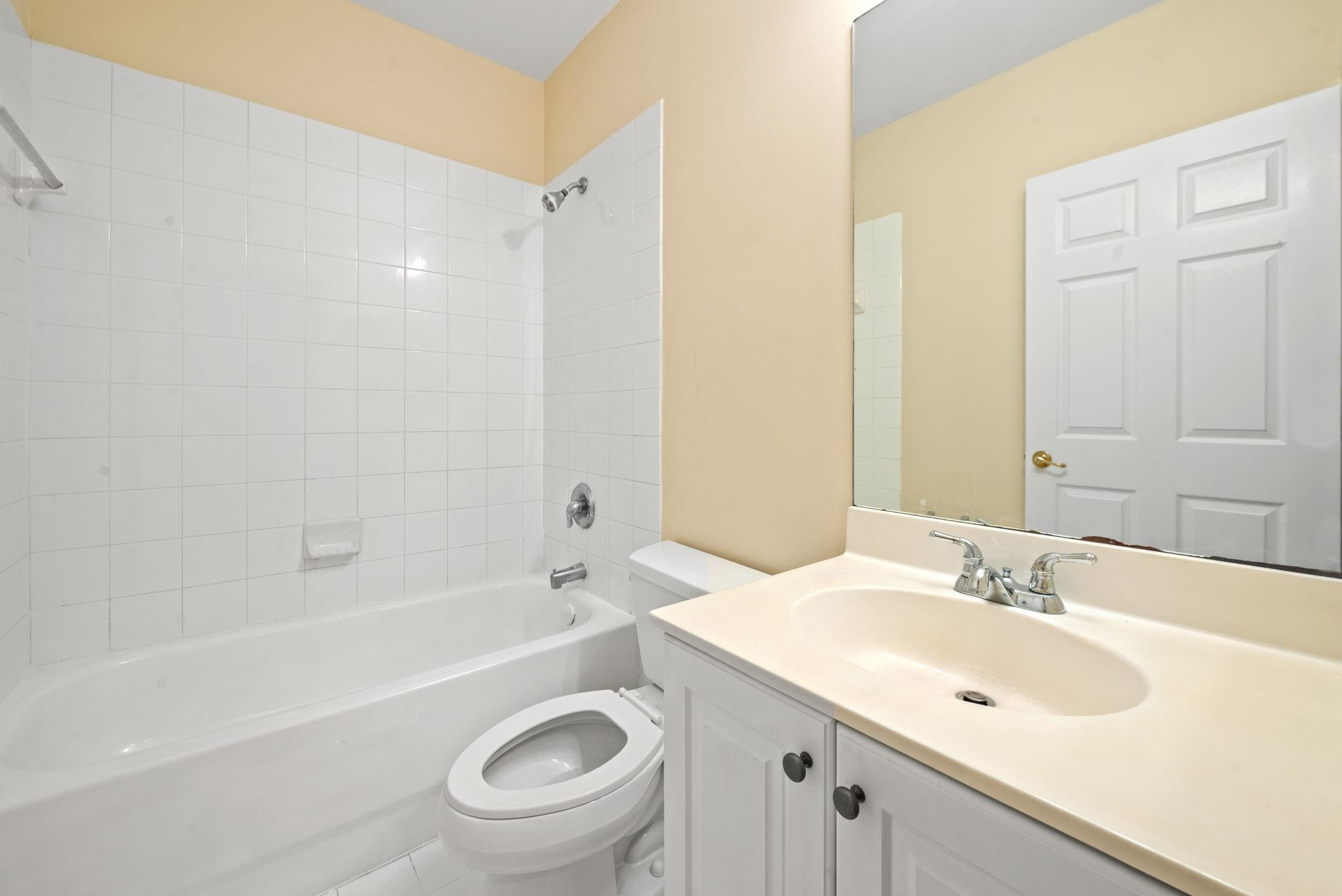 8299 Southwest 27th Street, Unit 101 Miramar, FL 33025 - Photo 18 of 30 a bathroom with a sink a toilet and shower