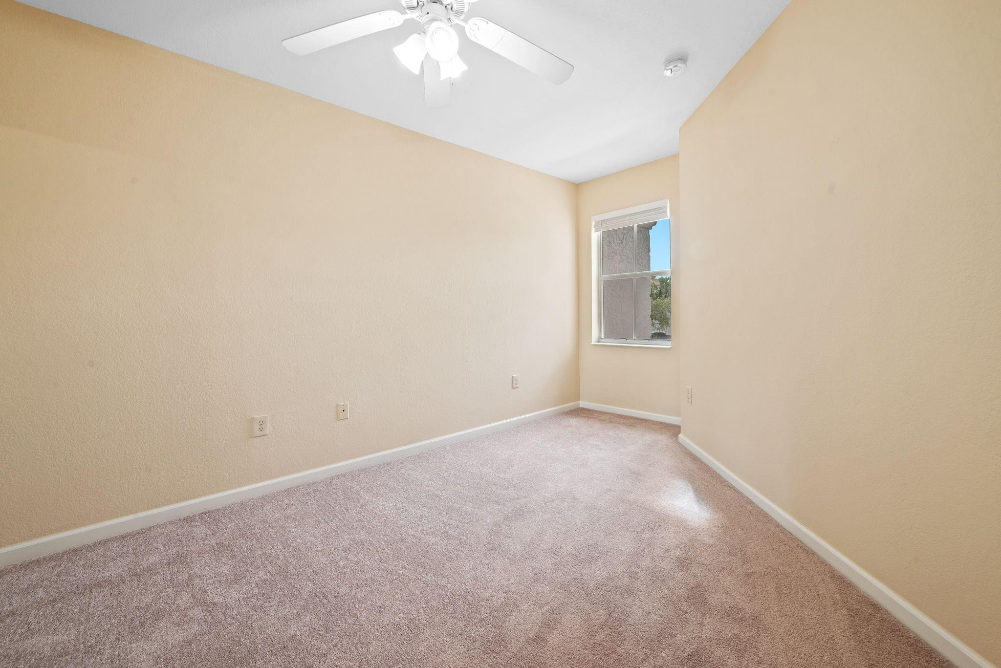 8299 Southwest 27th Street, Unit 101 Miramar, FL 33025 - Photo 19 of 30 an empty room with a chandelier fan