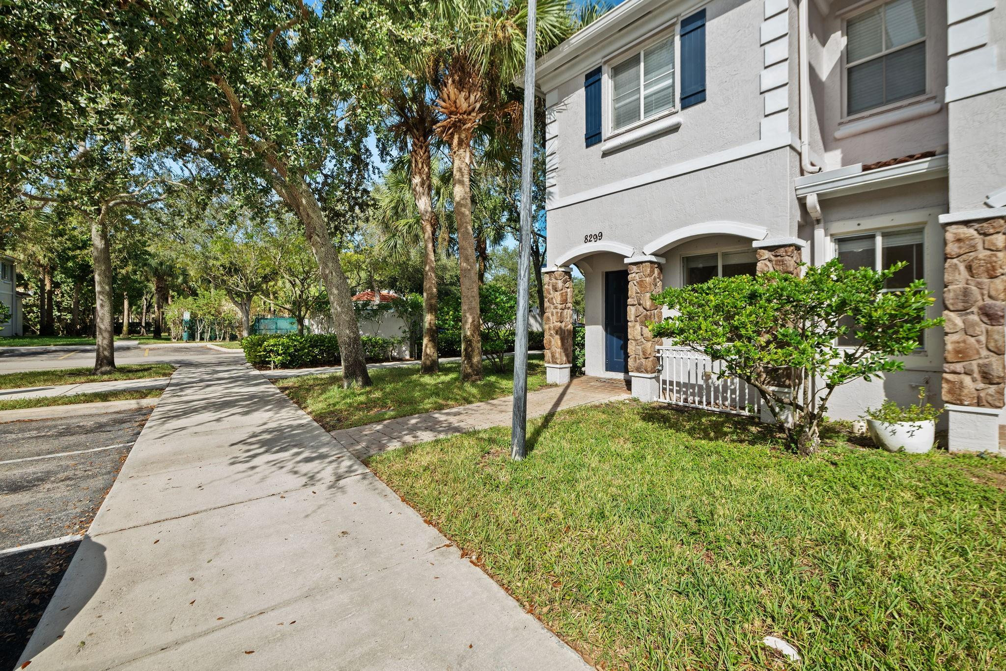 8299 Southwest 27th Street, Unit 101 Miramar, FL 33025 - Photo 2 of 30 a view of a house with a yard and sitting area