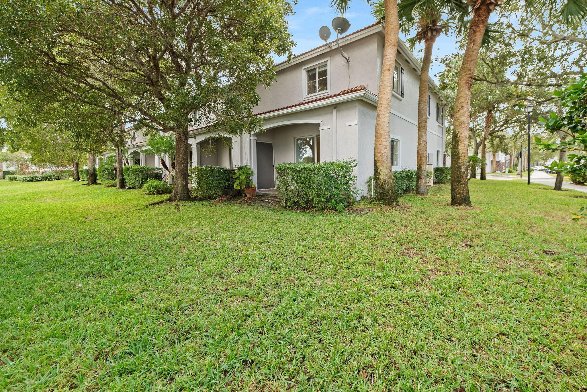 8299 Southwest 27th Street, Unit 101 Miramar, FL 33025 - Photo 23 of 30 a front view of a house with a yard