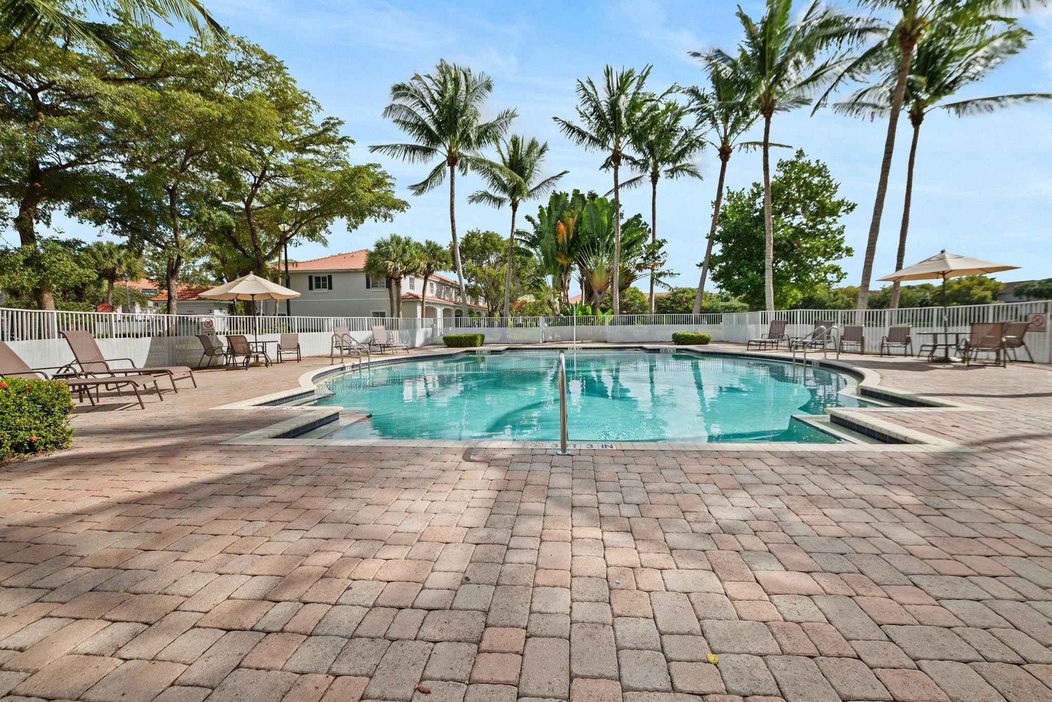 8299 Southwest 27th Street, Unit 101 Miramar, FL 33025 - Photo 30 of 30 a view of a backyard and swimming pool