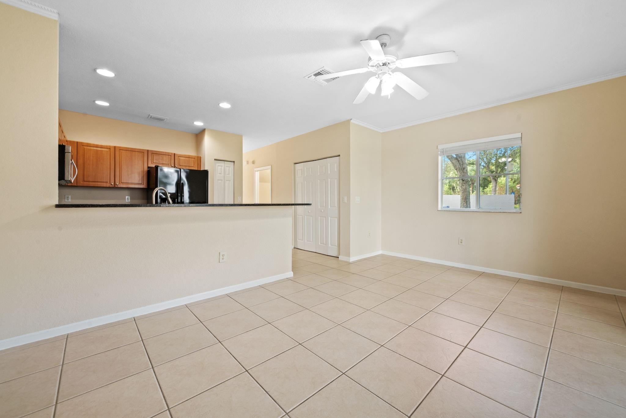 8299 Southwest 27th Street, Unit 101 Miramar, FL 33025 - Photo 7 of 30 a view of a kitchen with a sink and a refrigerator