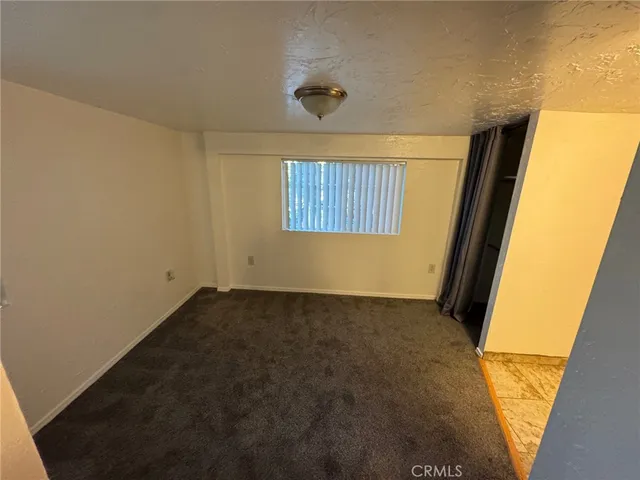 a view of an empty room and a window