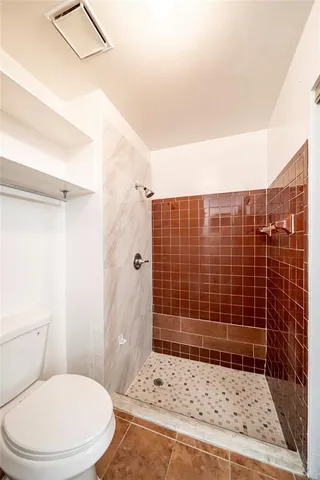 a bathroom with a toilet and shower