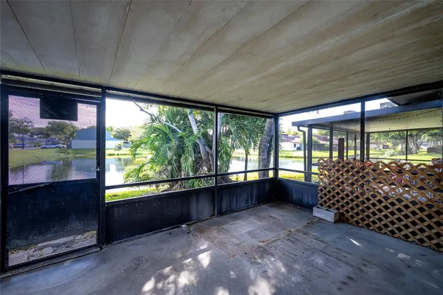 wooden floor in an empty room with a large window