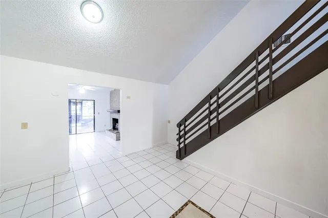 wooden floor with white walls and stairs