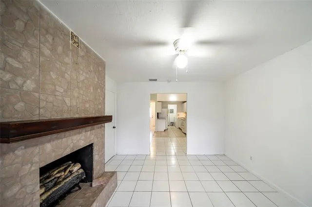 a view of an empty room and fire place