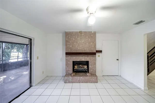 a view of an empty room and fire place