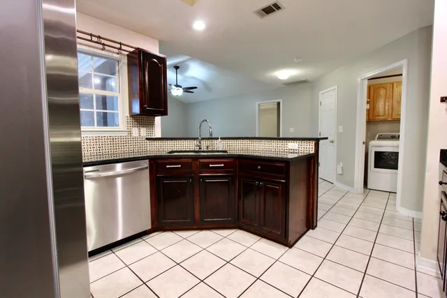 a kitchen with stainless steel appliances granite countertop a stove and a sink