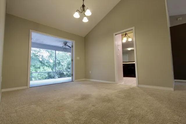 an empty room with windows and entrance