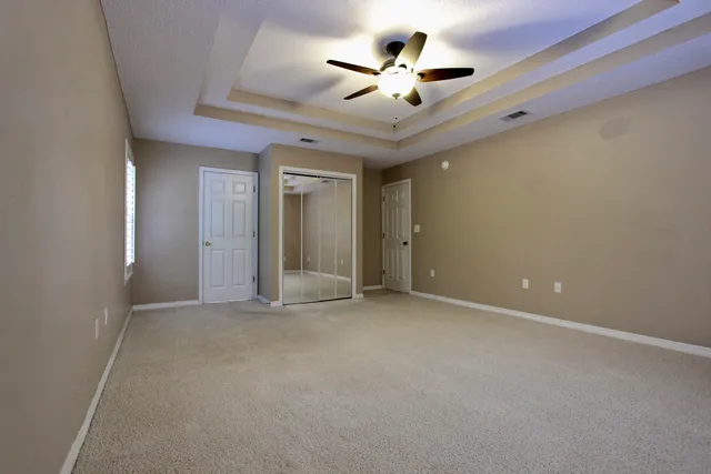 en view of an empty room with a ceiling fan