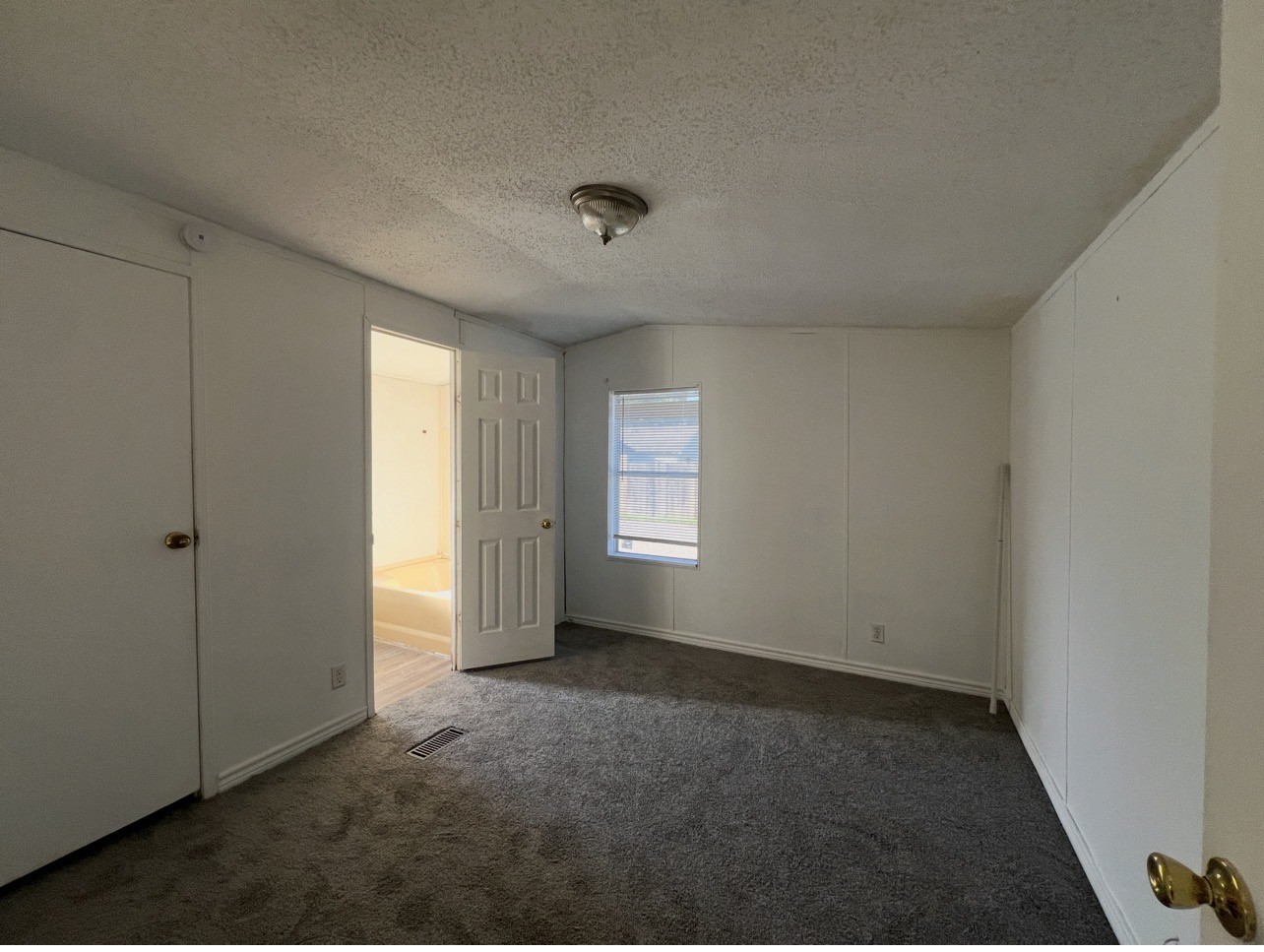 1511-4 Jones Street, Unit 4 Rosenberg, TX 77471 - Photo 3 of 11 an empty room with a empty space and windows