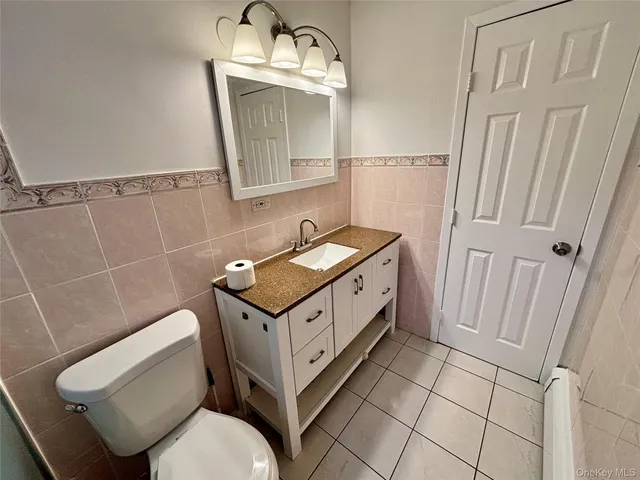 a bathroom with a sink a toilet and mirror
