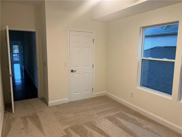 a view of an empty room with a closet