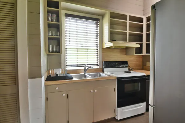 a kitchen with a sink and a stove