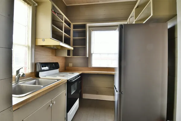 a kitchen with a sink and a refrigerator