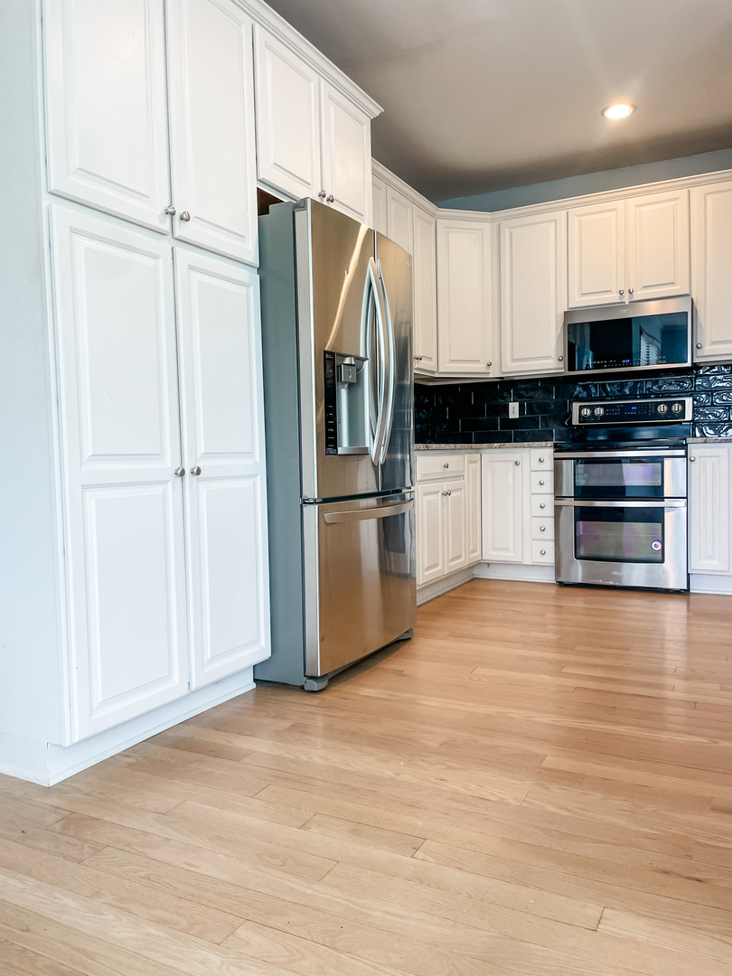 1308 Axcel Lane Sycamore, IL 60178 - Photo 2 of 40 a kitchen with stainless steel appliances a refrigerator and a stove top oven