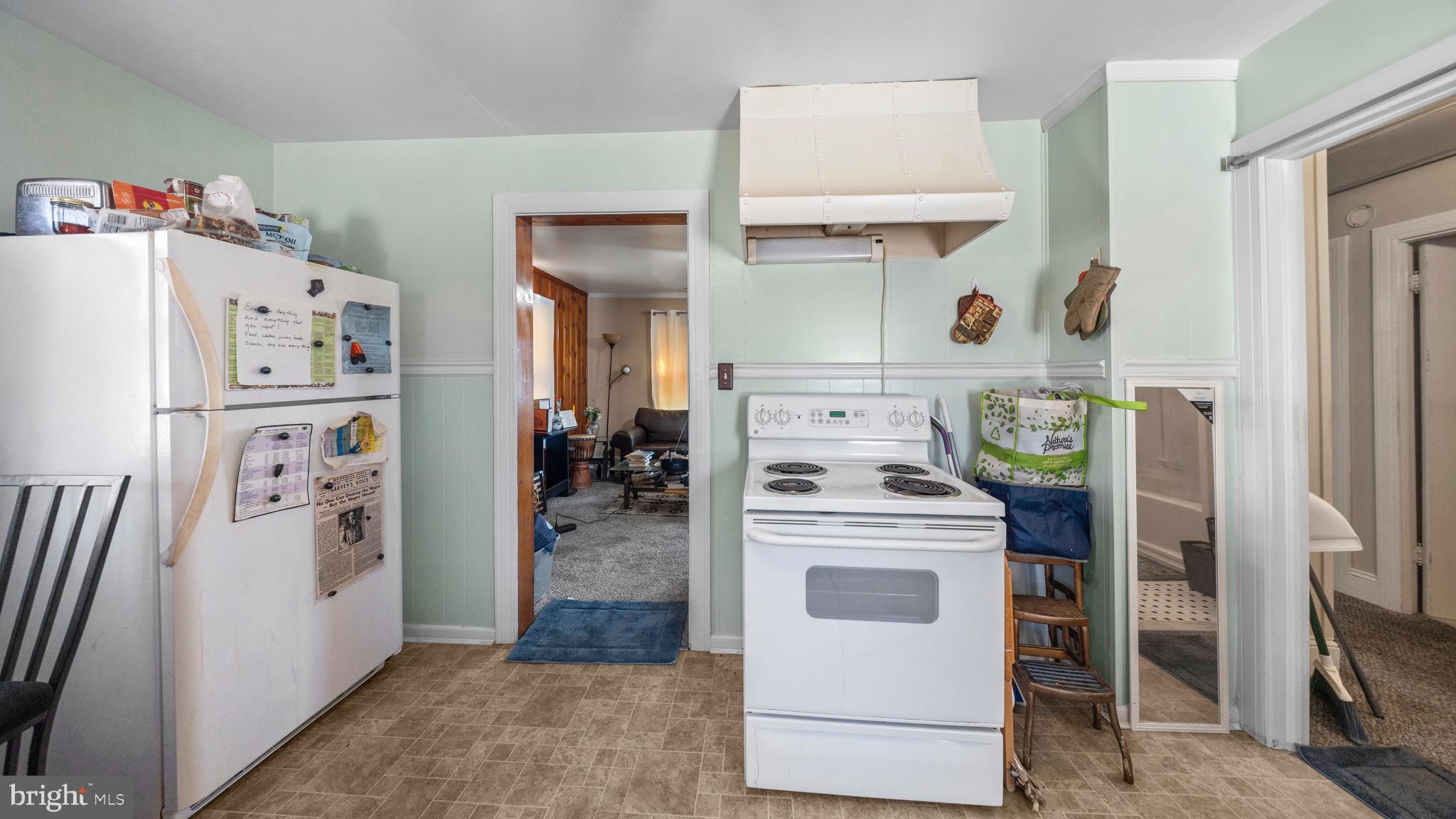 704 Madison Street Salisbury, MD 21804 - Photo 5 of 17 a kitchen with a refrigerator and washer dryer