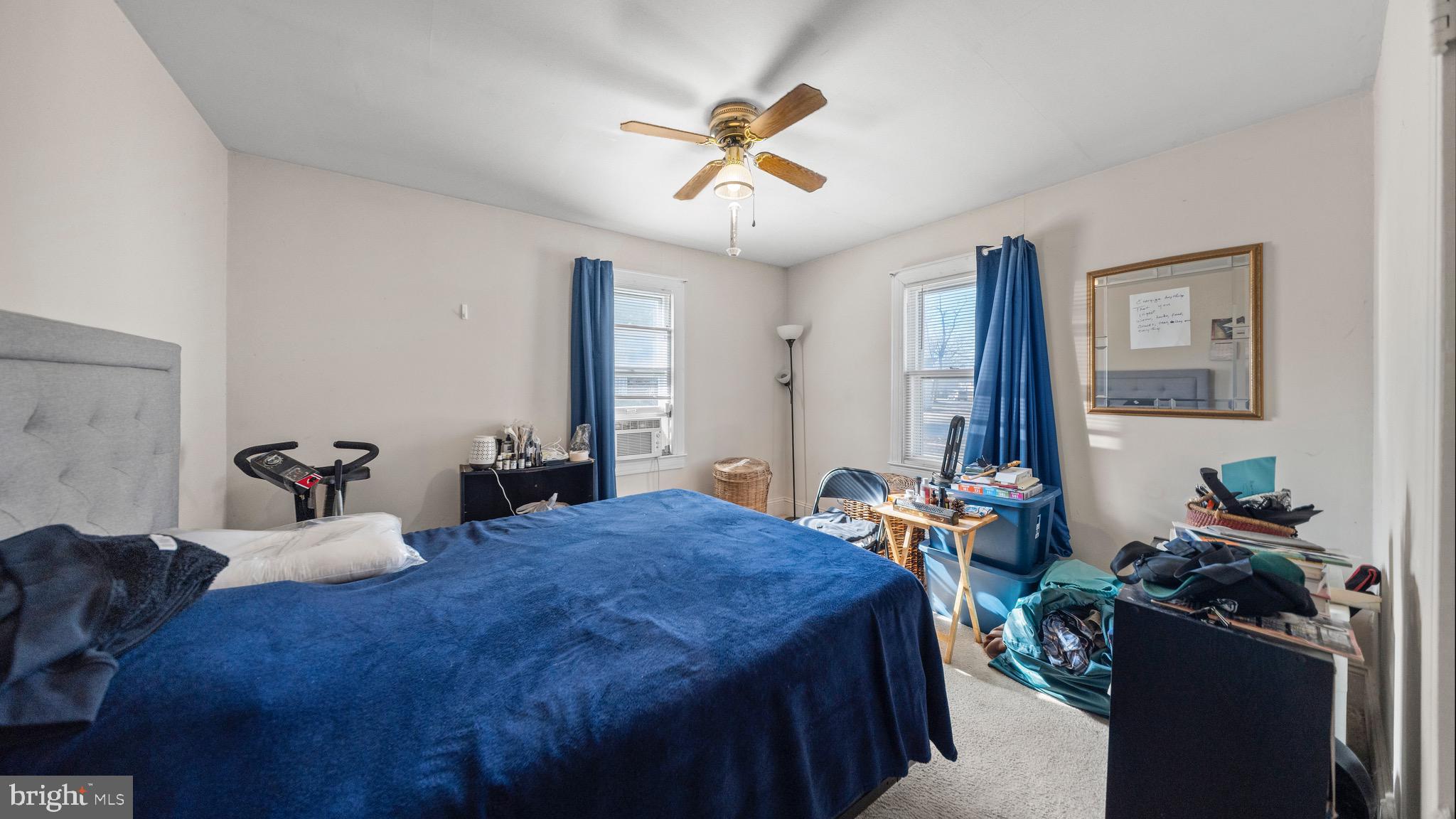 704 Madison Street Salisbury, MD 21804 - Photo 7 of 17 a bedroom with a bed and a chandelier