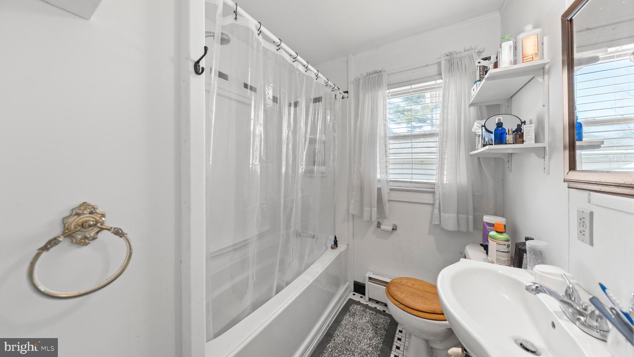 704 Madison Street Salisbury, MD 21804 - Photo 8 of 17 a bathroom with a sink a toilet and shower