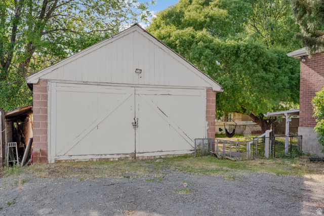 1275 North Geneva Road Provo, UT 84601 - Photo 25 of 25 Detached garage structure with white siding and double barn doors, complemented by a brick base
