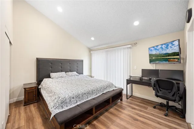 a bedroom with a bed and a desk