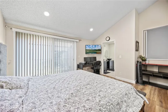 a bedroom with a bed and a television