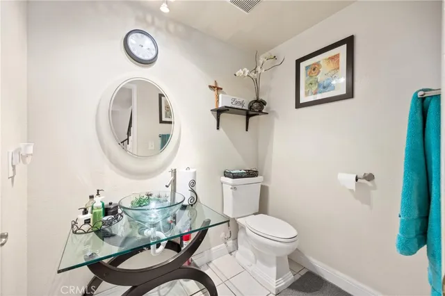 a bathroom with a toilet a sink and a mirror