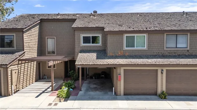 a view of a house with a balcony and wooden floor
